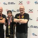 Freddie Carman with coaches Matt Mooney and Scott Harmon.