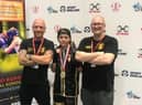 Freddie Carman with coaches Matt Mooney and Scott Harmon.