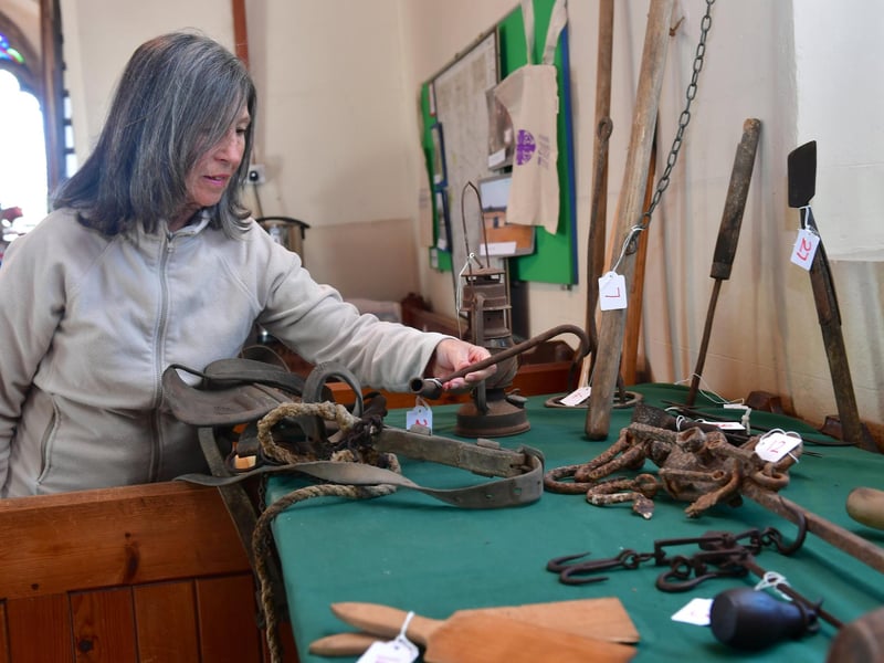 Sue Truelove of Hemingby takes a look at historic farming tools on display in the church.