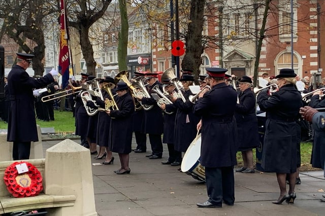 A brass band plays 'The Last Post' at Boston war memorial before a silence is held.