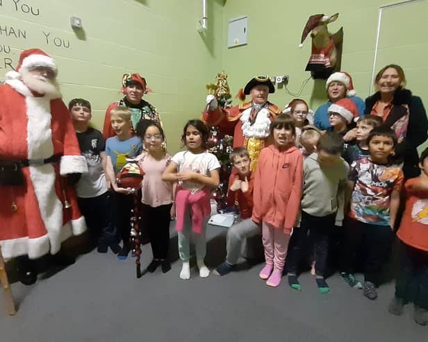 Children with Santa, Mablethorpe Town Crier David Summers, centre manager Ali Byerley  and Lisa Merick.