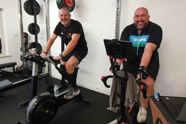 L-R - Ade Smith and Mark Booth were doing their stints on the exercise bikes for the challenge.