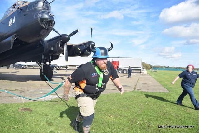 Ryan starts his feat of strength - pulling the 19-tonne aircraft. Photos by MKS Photography