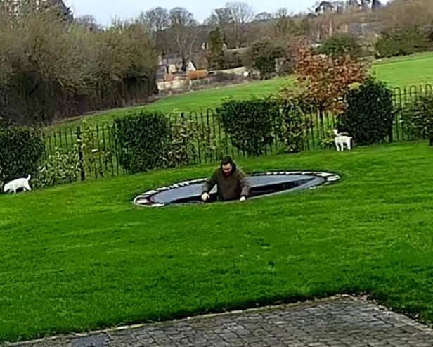Charlie Bond hits the water after plummeting through the trampoline