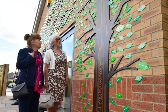 Friends of Stefan Novak, Helen Anastassiou and Avril Hart, looking at the tree with the names of all who have donated.