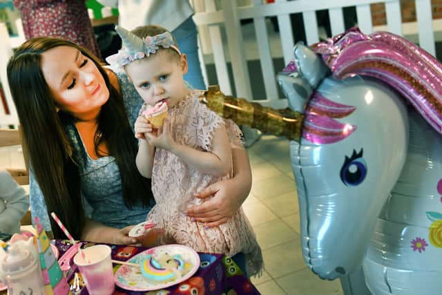 Emily with Lily at her fourth birthday party. Photo: Mick Fox