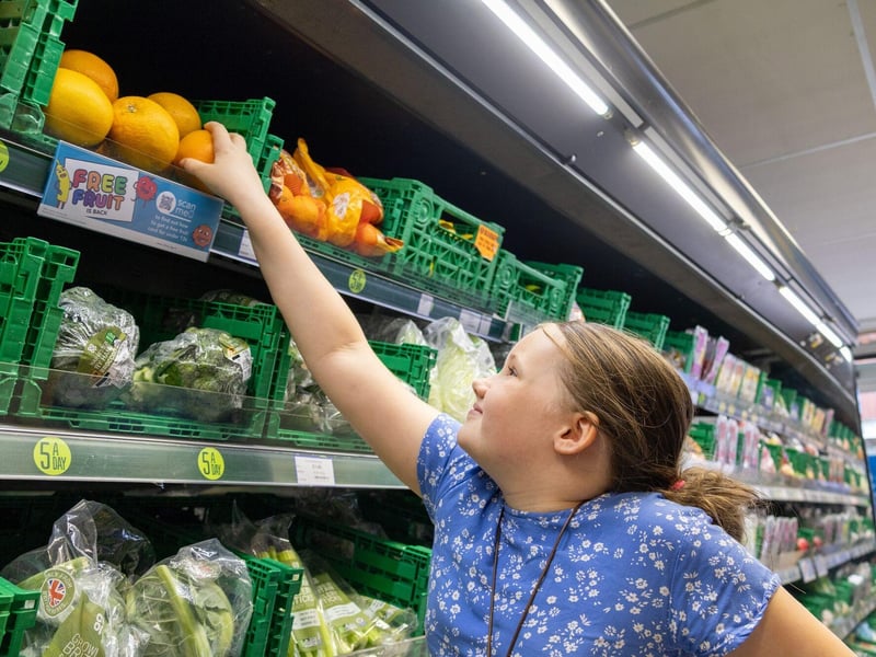 Olivia reaching for an orange, her favourite fruit