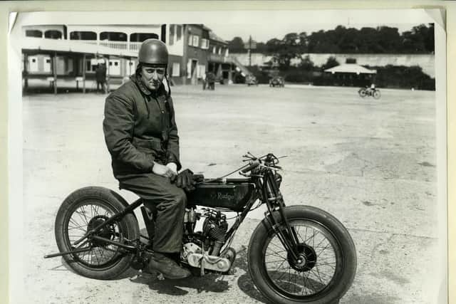 Collect image taken of Bert Mathers, one of the two record breaking riders, sitting on the 50-degree V-twin 998cc Rudge motorcycle outside the clubhouse at Brooklands before or after a race in 1922.credit: ©The Hartley Collection Brooklands Museum.