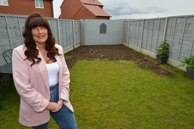 Vicky Strange in her rear garden, which has had flooding issues - now being resolved by Gleeson Homes.