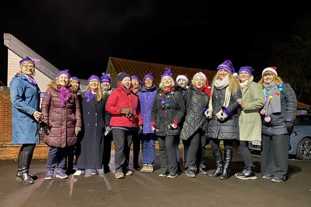 Members of the Zero Degree Choir singing Christmas Carols in the School's playground.