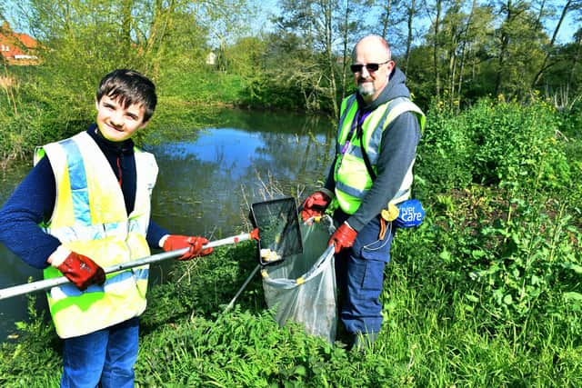 Matthew Kirby and Michael Kirby cleaning up the River Waring.