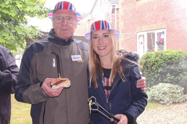 Glyn Hall and Emma Boxall serving up burgers at the street party in Grange Close, Ruskington - despite the rain!
