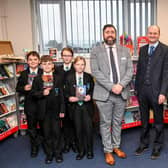 Principal Philip Dickinson, and CEO Martin Brown with pupils in the library. Photo by Jon Corken