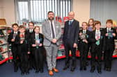 Principal Philip Dickinson, and CEO Martin Brown with pupils in the library. Photo by Jon Corken