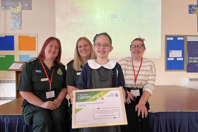 Evalyn holds her award, pictured with her mum (right) and Katie Best, specialist practitioner,and Jenna Rowett, dispatcher.
