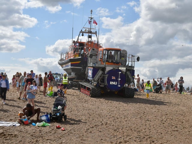Spectators followed the lifeboats to the waters edge.