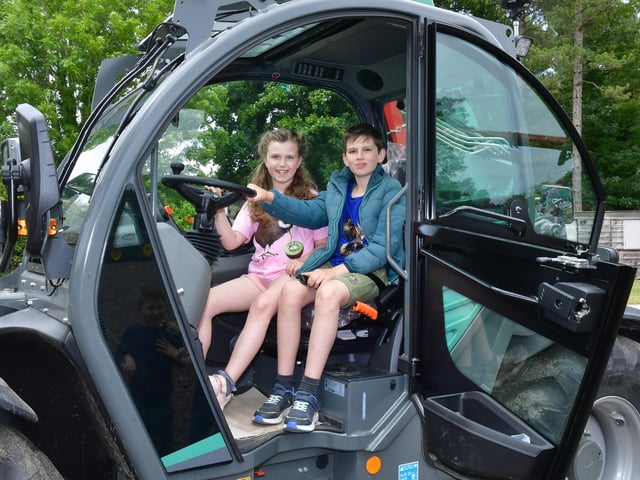 Georgia Sutemire-Mackay 7 and Edward Sutemire-Mackay 10 of Carrington try the modern machinery for size. Photo: David Dawson