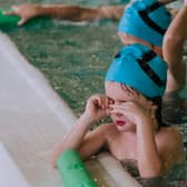 Children taking part in a swimming lesson.