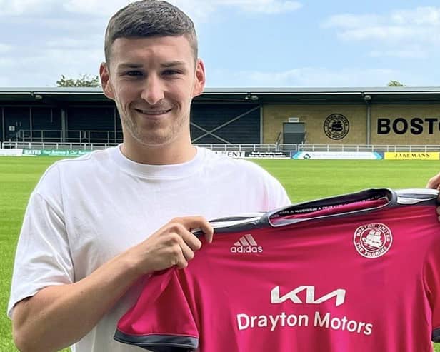 Alex Brown shows off Boston United's new pink away kit.