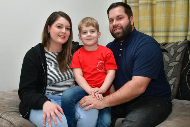 Parents Danielle Ballam and Chris Hough, with young William wearing a 'Heart Link' charity t-shirt.