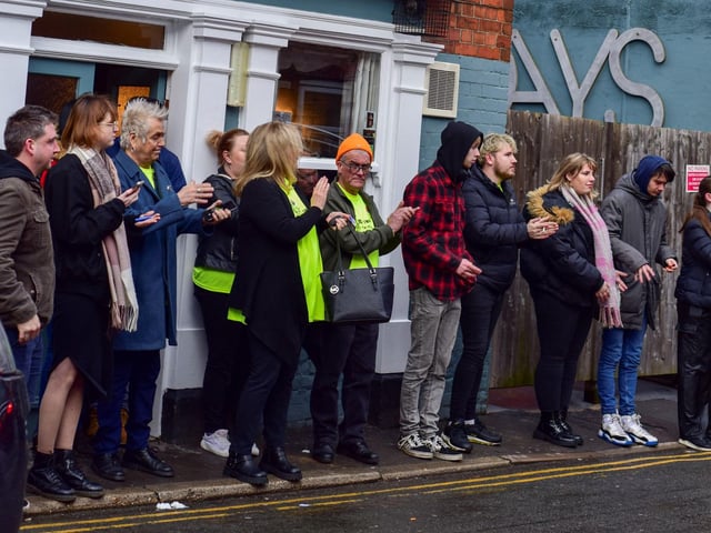 Friends clap as Adi's coffin arrives