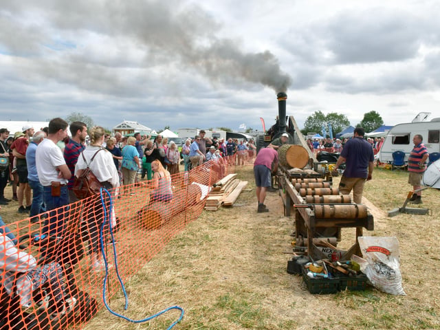 Steam traction engine-powered sawmill in action at the show.