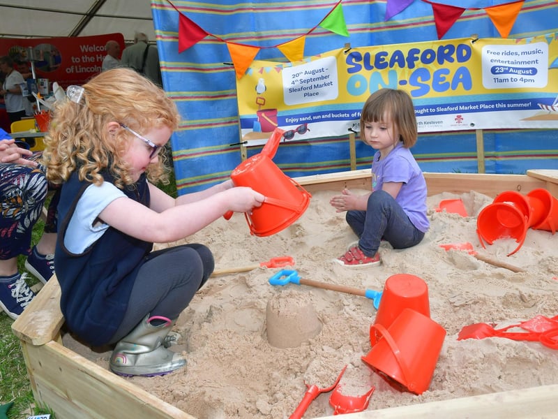 Nala Shelbourn 4 of Metheringham and Pippa Windle 2 of Cranwell at the NKDC stand 'beach'.