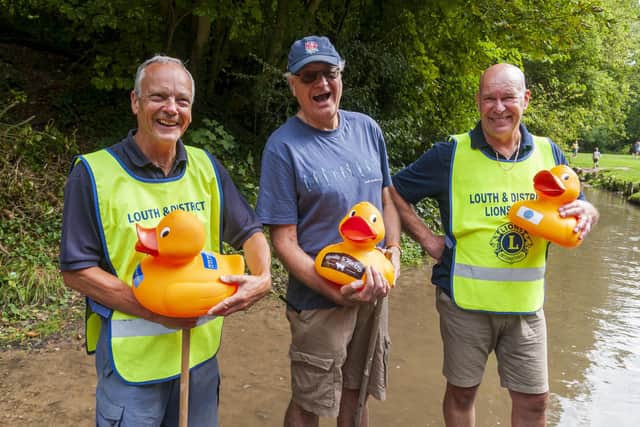 Three members of Louth Lions with Ducks sponsored by local businesses.