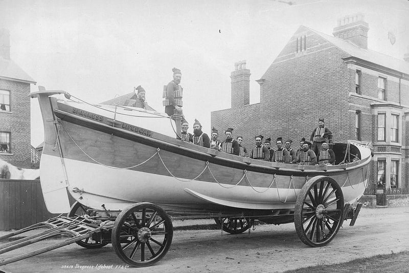 The Skegness lifeboat and crew, wearing lifejackets, on a trailer, ready for action.