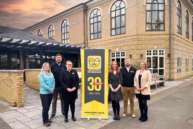 Staff members from Belton Woods Hotel and WCF Chandlers with Joe Harper from the Lincs & Notts Air Ambulance outside the Belton Woods Hotel at Grantham