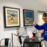 Jolly the Fisherman mascot with the two John Hassall poster paintings, before they were sent off for conservation work.