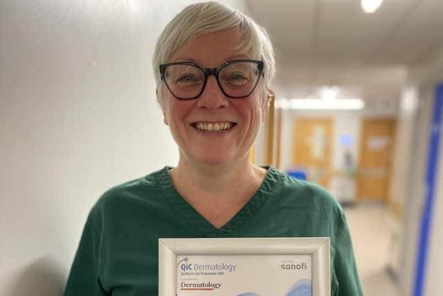 Nicola with her certificate and award at work