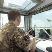 An air and space operations specialist at the air traffic control centre watching an aircraft depart from RAF Coningsby.