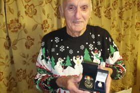 John with his Nuclear Test Medal and Armed Services badge.