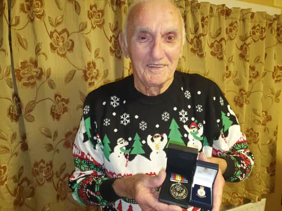 John with his Nuclear Test Medal and Armed Services badge.