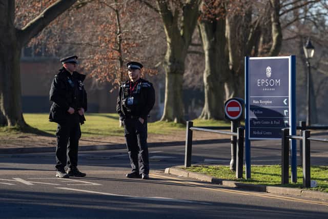 Police officers stand guard inside Epsom College after the school's head, Emma Pattison, was found dead alongside her family  on February 6, 2023 in Epsom. Pattison, her husband George, and 7-year-old daughter Emma were found dead in a property on school grounds early on Sunday morning. (Photo by Carl Court/Getty Images)
