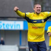 Striker Gregg Smith celebrates with the travelling supporters after the 1-0 win at Lancaster on Saturday. PHOTO: John Rudkin