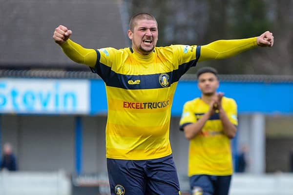 Striker Gregg Smith celebrates with the travelling supporters after the 1-0 win at Lancaster on Saturday. PHOTO: John Rudkin
