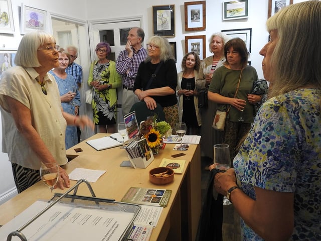 Mary Newman gives a speech to guests at the exhibition viewing.
