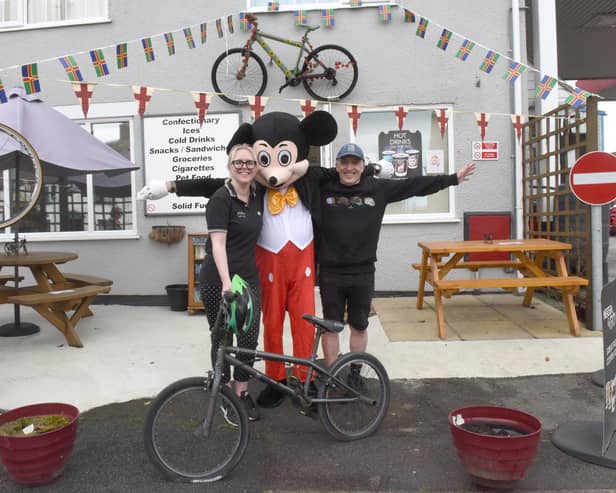 Ready to welcome the riders Mark and Emily Simon of Pit Stop Garage, Market Rasen with Mickey Mouse