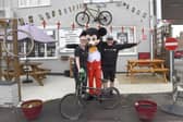 Ready to welcome the riders Mark and Emily Simon of Pit Stop Garage, Market Rasen with Mickey Mouse
