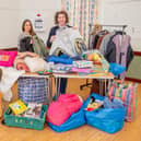 Nancy Benilde, volunteer and Community Larder organiser Isabel Forrester sort through the donated clothes.