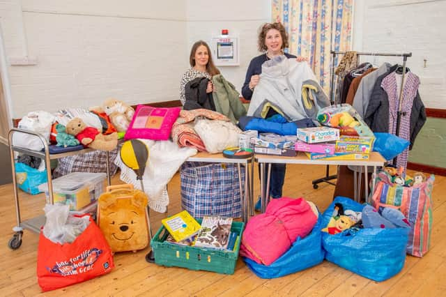 Nancy Benilde, volunteer and Community Larder organiser Isabel Forrester sort through the donated clothes.