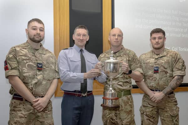 Station Commander, Group Captain Paul (Pablo) O’Grady presents the Dog Handlers with their trophy. Photo: Shauna Martin RAF