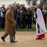King Charles and Queen Camilla entering the church at Sandringham, greeted by the Archbishop of Canterbury Justin Welby.