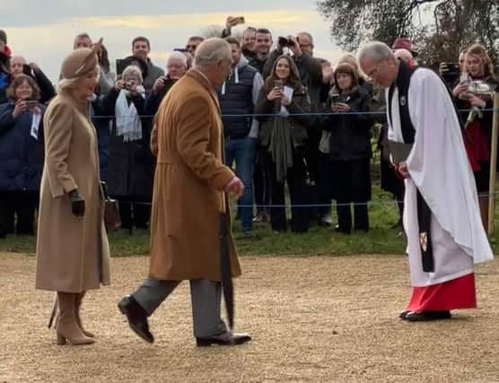 King Charles and Queen Camilla entering the church at Sandringham, greeted by the Archbishop of Canterbury Justin Welby.