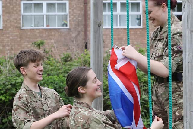 All smiles as cadets put up bunting for the picnic.