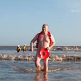 Steve Atherton emerges from the sea at the Mablethorpe Big Dip in his distinctive poppy ensemble.