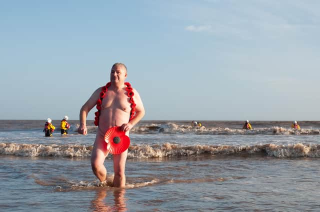 Steve Atherton emerges from the sea at the Mablethorpe Big Dip in his distinctive poppy ensemble.