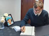 Coun Stephen Bunney was the first to sign the Book of Condolence
